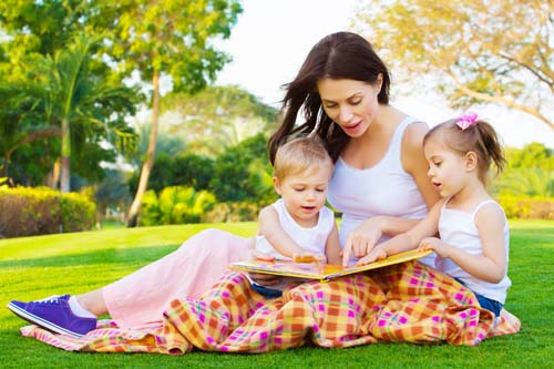 young-brunette-woman-reading-to-two-kids