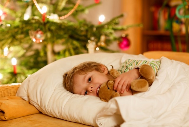 Adorable blond child sleeping with teddy bear under Christmas tree and dreaming of Santa at home indoors. Happy kid boy waiting for gifts.
** Note: Soft Focus at 100%, best at smaller sizes